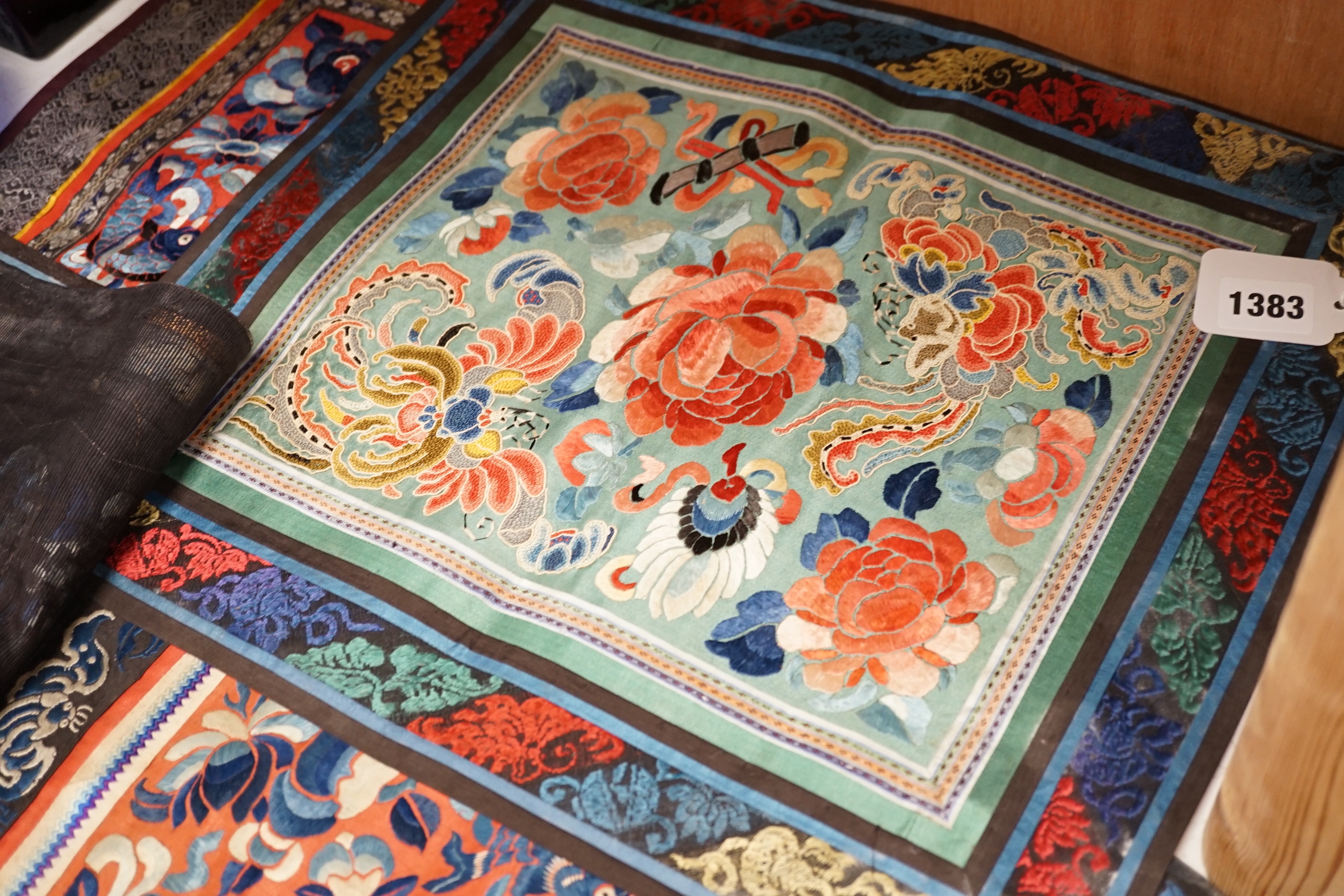 Six panels of Chinese silk embroidered mats, all using mixed stitches including Beijing knot, all bordered with silk brocade, largest 36 x 41cm